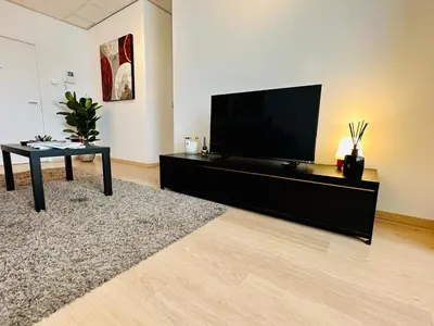 a living room with a flat screen tv and a table at Urbanstay Suites - Grand Place 2 Bd Penthouse in Brussels