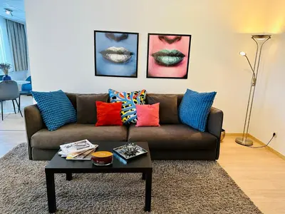 a living room with a brown couch with colorful pillows at Urbanstay Suites - Grand Place 2 Bd Penthouse in Brussels