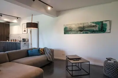 a living room with a couch and a table at De verloren hoek in Aarschot