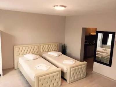a bedroom with two beds and a mirror at Prestige Flats in Brussels