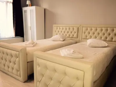 two beds in a bedroom with towels on them at Prestige Flats in Brussels