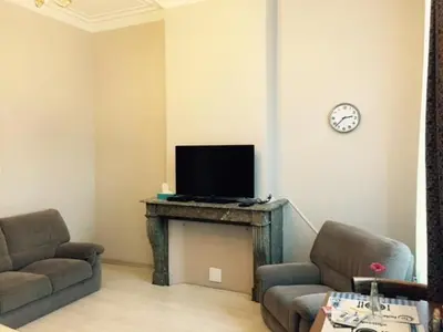 a living room with two couches and a television at Prestige Flats in Brussels