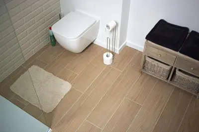 a bathroom with a white toilet and a shower at Maison Raymond - Vakantiehuisje met houtgestookte sauna in Melsen