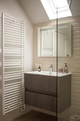a bathroom with a sink and a mirror at Maison Raymond - Vakantiehuisje met houtgestookte sauna in Melsen
