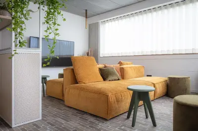 a living room with a couch and a table at Gare 55 in Evergem