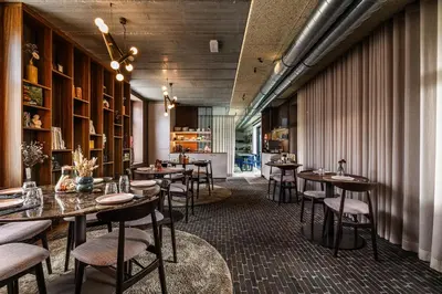 a restaurant with tables and chairs in a room at Gare 55 in Evergem