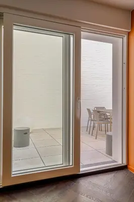 a sliding glass door with a view of a patio at Uma's Urban Lounge in Mechelen