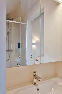 a bathroom with a sink and a mirror at Uma's Urban Lounge in Mechelen
