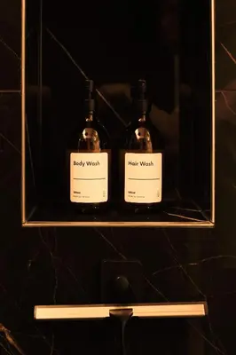 two bottles ofappy worth sitting on a shelf at De Pastorie Alsemberg B&B in Beersel