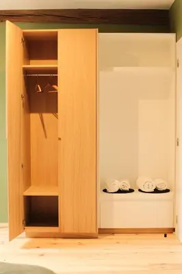 a cupboard with some folded towels in it at De Pastorie Alsemberg B&B in Beersel