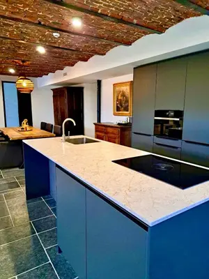 a kitchen with a blue island with a sink at HVN10 - Near Antwerp in Stabroek