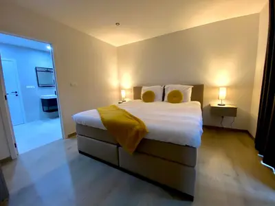 a bedroom with a large bed with two yellow pillows at HVN10 - Near Antwerp in Stabroek