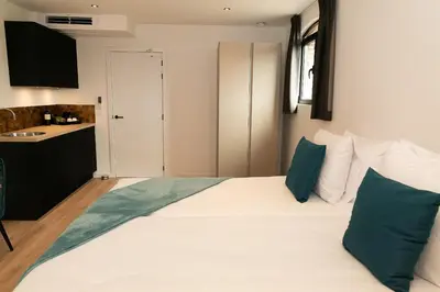 a bedroom with a large white bed with blue pillows at HVN10 - Near Antwerp in Stabroek
