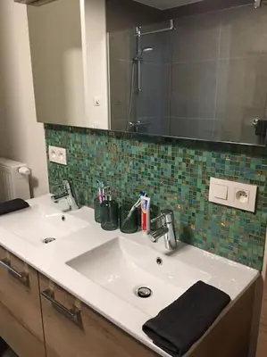 a bathroom with a white sink and a mirror at Leuk overnachten in hartje Laarne, dicht bij Gent! in Laarne