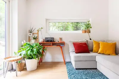 a living room with a couch and a desk at Luxe-Avontuur in een Romantische Cabin in het Bos in Stekene