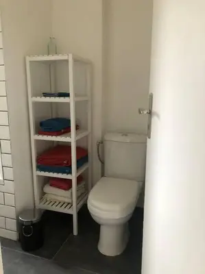 a bathroom with a white toilet in a room at Quartier Diamant in Brussels
