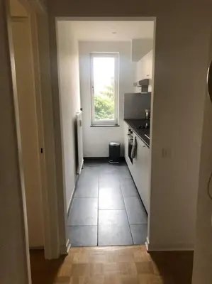 a hallway of a kitchen with a window at Quartier Diamant in Brussels