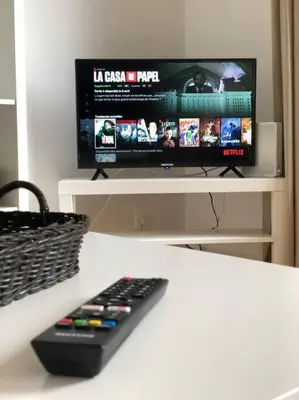 a remote control sitting on a table in front of a television at Quartier Diamant in Brussels