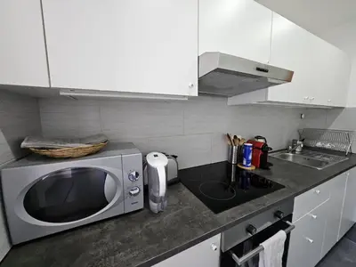 a kitchen with a microwave and a sink at Quartier Diamant in Brussels
