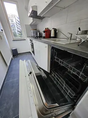 a kitchen with an empty dish rack in an oven at Quartier Diamant in Brussels