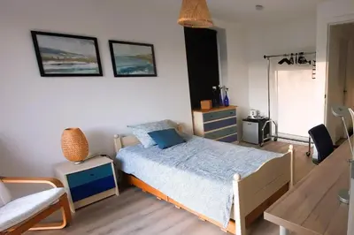a bedroom with a bed and a couch at BnB Waterzicht in Wijnegem