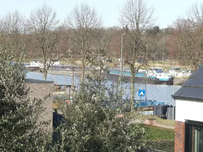 a view of a river with boats in the water at BnB Waterzicht in Wijnegem