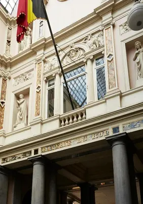 a building with a flag in front of it at Hotel des Galeries in Brussels