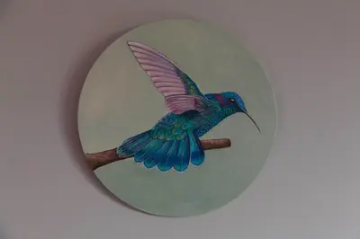 a blue bird on a branch in a round clock at Guest House Les 3 Tilleuls in Brussels