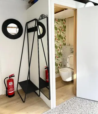 a bathroom with a mirror next to a toilet at Large Quiet Charming Rooms in House near Historic Gent Centre in Ghent