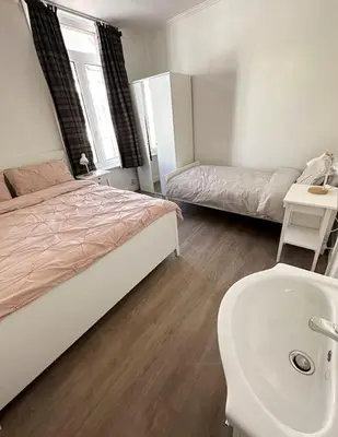 a bedroom with a bed and a sink and a sink at Large Quiet Charming Rooms in House near Historic Gent Centre in Ghent