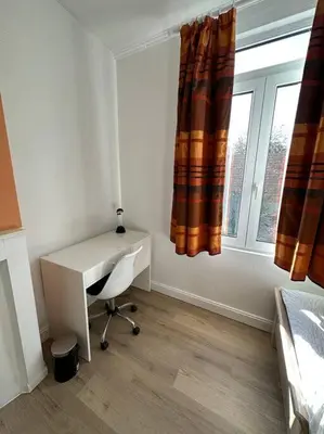 a desk and a chair in a room with a window at Large Quiet Charming Rooms in House near Historic Gent Centre in Ghent