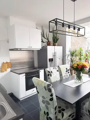 a kitchen with a table and chairs in a kitchen at Large Quiet Charming Rooms in House near Historic Gent Centre in Ghent