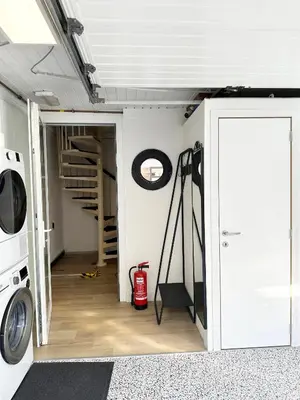 a laundry room with a washing machine and a door at Large Quiet Charming Rooms in House near Historic Gent Centre in Ghent