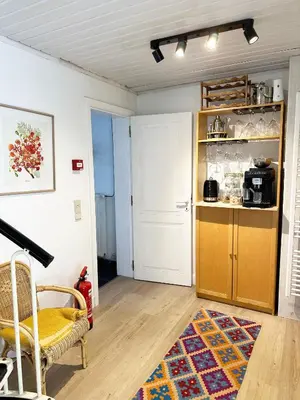 a living room with a table and a kitchen at Large Quiet Charming Rooms in House near Historic Gent Centre in Ghent
