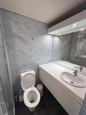 a bathroom with a white toilet and a sink at Large Quiet Charming Rooms in House near Historic Gent Centre in Ghent