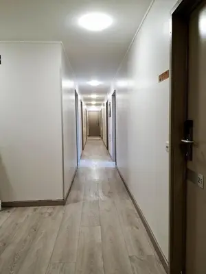 an empty hallway with white walls and wooden floors at Hotel New Flanders in Sint-Niklaas