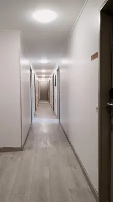 an empty hallway with white walls and a long corridor at Hotel New Flanders in Sint-Niklaas