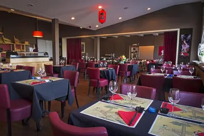 a dining room with tables and chairs with wine glasses at Hotel New Flanders in Sint-Niklaas