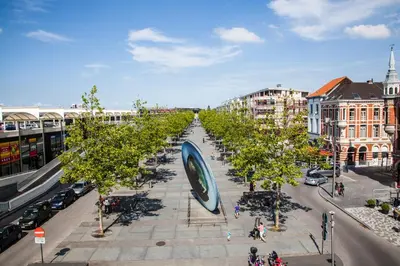 a street lined with trees in a city at Hotel New Flanders in Sint-Niklaas