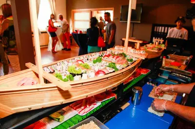 a buffet line with sushi and other foods on display at Hotel New Flanders in Sint-Niklaas