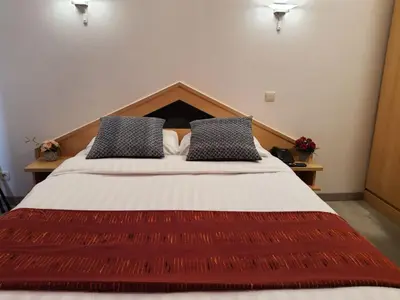 a bedroom with a large bed with two pillows at Hotel New Flanders in Sint-Niklaas