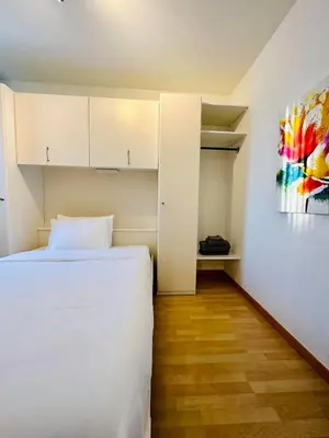 a bedroom with a bed and a painting on the wall at Urbanstay Suites Apartment In Charming Sablon in Brussels