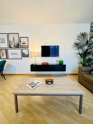 a living room with a coffee table and a tv at Urbanstay Suites Apartment In Charming Sablon in Brussels