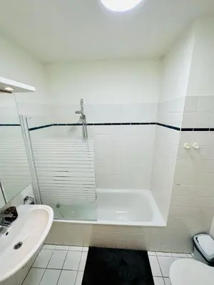 a white bathroom with a tub and a sink at Urbanstay Suites Apartment In Charming Sablon in Brussels