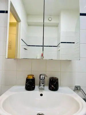 a bathroom with a sink and a mirror at Urbanstay Suites Apartment In Charming Sablon in Brussels