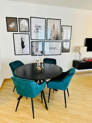 a dining room with a black table and blue chairs at Urbanstay Suites Apartment In Charming Sablon in Brussels
