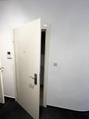 a white door with a handle in a room at Amazing flat-Center of Brussels in Brussels