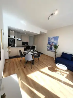 a living room with a blue couch and a table at Amazing flat-Center of Brussels in Brussels