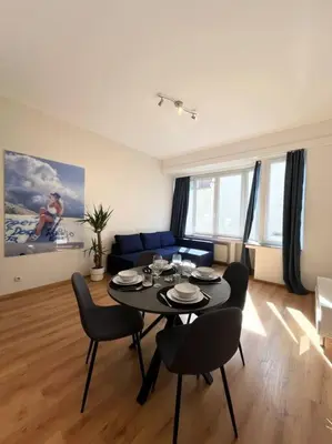 a living room with a black table and chairs at Amazing flat-Center of Brussels in Brussels