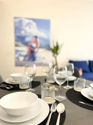 a table with plates and wine glasses on it at Amazing flat-Center of Brussels in Brussels